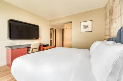 a hotel room with a bed and a flat screen tv at Toor Hotel Toronto, Part Of Jdv By Hyatt in Toronto