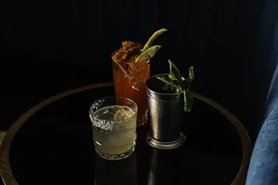 a table with a drink and a vase with a plant at Toor Hotel Toronto, Part Of Jdv By Hyatt in Toronto