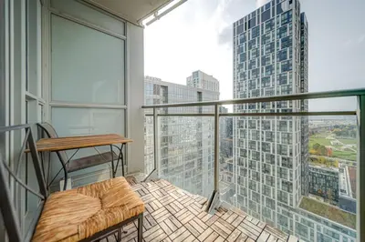 a balcony with a bench and a view of a building at The Hideaway Hub in Toronto