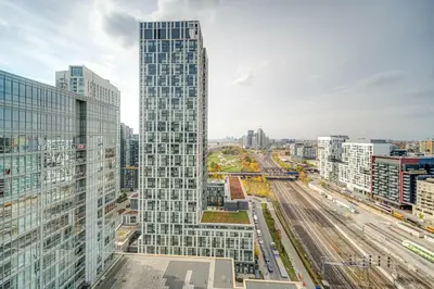 a tall glass building in the middle of a city at The Hideaway Hub in Toronto