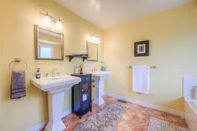 a bathroom with two sinks and a mirror at 45 per Off Monthly Stay - 7 Beds - BBQ in Kitchener
