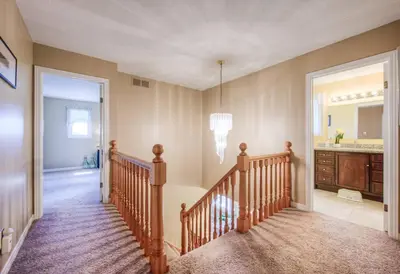 a room with a staircase with a sink and a mirror at 45 per Off Monthly Stay - 7 Beds - BBQ in Kitchener