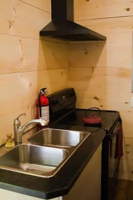 a kitchen with a sink and a stove at The Green Acres Cabin in Hamilton
