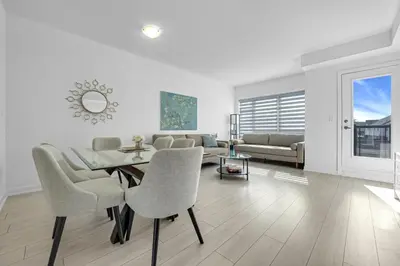 a living room with a table and chairs and a couch at Posh 4 Bed Home with Backyard in Great Location in Burlington