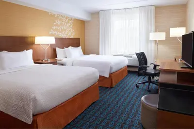 a hotel room with two beds and a desk at Fairfield Inn & Suites by Marriott Barrie in Barrie