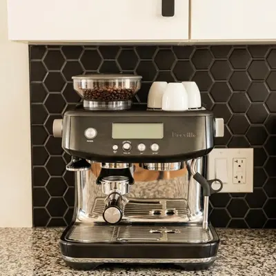 a black coffee maker sitting on a kitchen counter at Beautiful modern 2Bdr sunny home with French decor in Hamilton