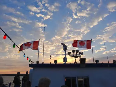 three canadian flags on the top of a boat at The Captain's House heritage bed & breakfast in Midland