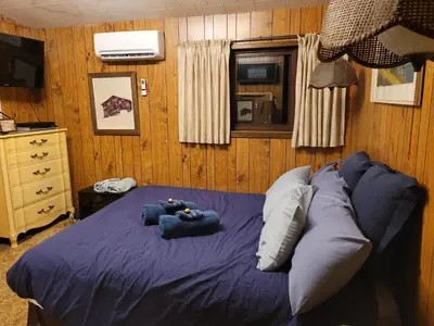 a bedroom with a bed with two teddy bears on it at Bowering Lodge in Blue Mountains