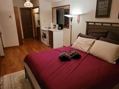 a bedroom with a bed with two pairs of shoes on it at Bowering Lodge in Blue Mountains