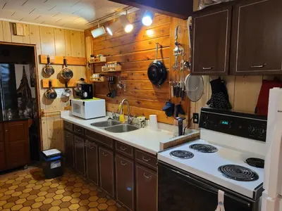 a kitchen with a sink and a stove top oven at Bowering Lodge in Blue Mountains