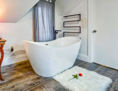 a bathroom with a large white tub in a room at Moon River in Campbellford
