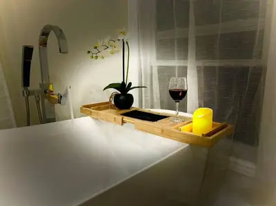 a wooden tray with a glass of wine and a plant at River Runs Through It in Belleville