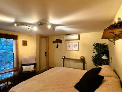 a bedroom with a large bed and a window at The Cozy Corner in Elora