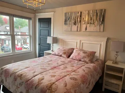a bedroom with a large bed and a window at Luxury and comfy Home- Niagara getaway in Niagara Falls