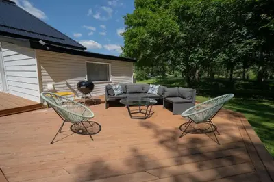 a patio with a couch and chairs and a table at Carson's Creek in Hillier