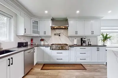 a white kitchen with white cabinets and a sink at Newly renovated luxury villa in Stouffville, ON in Stouffville