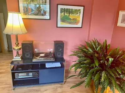 a room with a table with speakers and a lamp at Big apartment by the Farmers market in Kitchener
