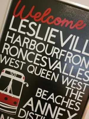 a sign for a bus stop with a bus at Cozy 3BR Retreat with Dedicated Work table and Parking in Toronto