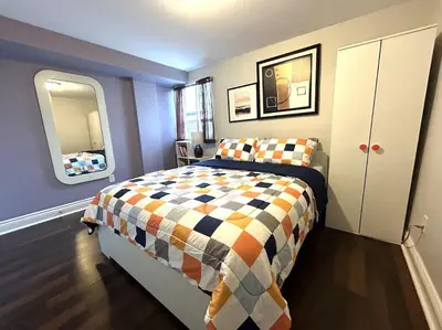 a bedroom with a bed and a large mirror at 2 bedroom rental apartment , 1 sofa bed, 2 car parking in Mississauga