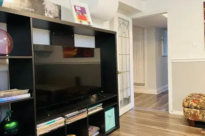 a large black entertainment center with a flat screen tv at 2 bedroom rental apartment , 1 sofa bed, 2 car parking in Mississauga