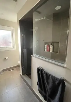 a bathroom with a shower with a black towel at Family-Friendly Retreat for 14 in Richmond Hill in Richmond Hill