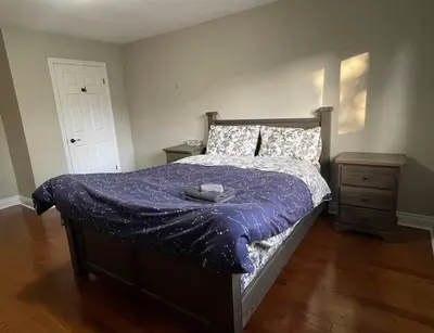 a bedroom with a bed with a purple comforter at Family-Friendly Retreat for 14 in Richmond Hill in Richmond Hill