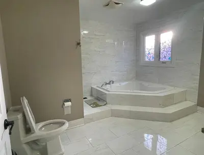 a white bathroom with a tub and a toilet at Family-Friendly Retreat for 14 in Richmond Hill in Richmond Hill