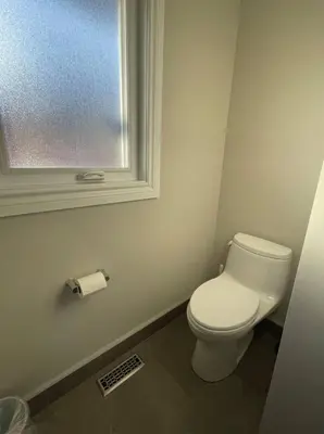 a bathroom with a white toilet and a window at Family-Friendly Retreat for 14 in Richmond Hill in Richmond Hill