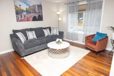 a living room with a couch and a coffee table at Beautiful House 2 bedroom in Belleville