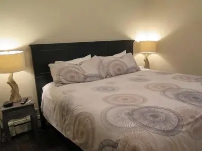 a bedroom with a large bed with two lamps at Western Hotel & Executive Suites in Guelph