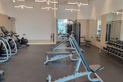 a gym with several treadmills and exercise bikes at Lakeview Escape Endy KING BED in Pickering