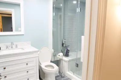 a bathroom with a toilet and a glass shower at Fully Furnished Guest Suite in Richmond Hill