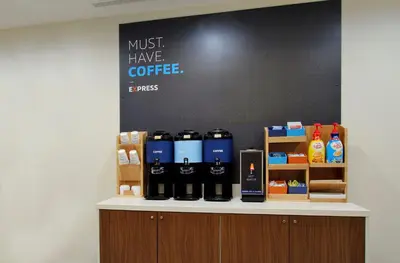 a counter with bottles of coffee on it at Holiday Inn Express Hamilton - Upper James by IHG in Hamilton