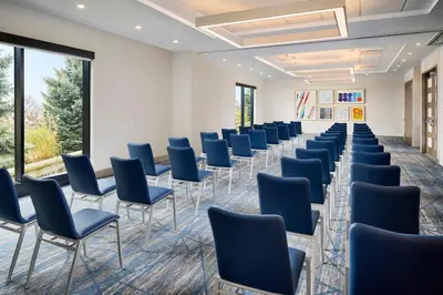 a row of chairs in a room with windows at Holiday Inn Express Hamilton - Upper James by IHG in Hamilton