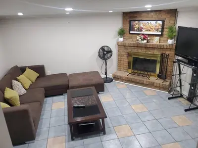 a living room with a couch and a fireplace at Home away from home in Brampton