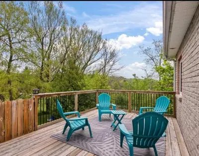 a deck with four blue chairs and a fence at Summer Getaway with Pool and Nearby Attractions in Cobourg