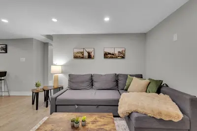 a living room with a gray couch and a table at 6BR house near Shops, Transit, Hwy and GO in Mississauga