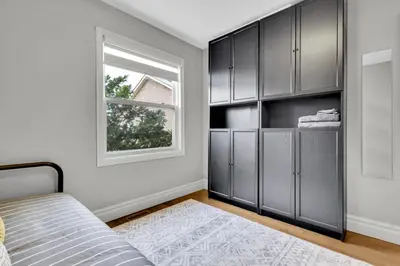 a bedroom with black cabinets and a window at 6BR house near Shops, Transit, Hwy and GO in Mississauga