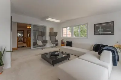a living room with a couch and a table at Luxury Hillside Farmhouse on The Bay of Quinte in Belleville