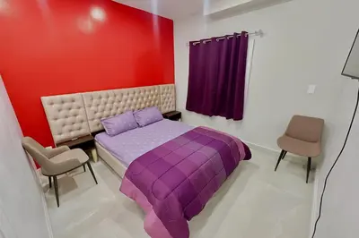 a bedroom with a purple bed and a chair at Private Room In Cambridge B9 in Cambridge