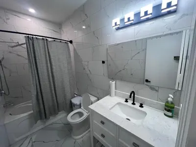 a bathroom with a sink and a toilet and a mirror at Private Room In Cambridge B4 in Cambridge