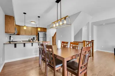 a kitchen and dining room with a table and chairs at Cozy 3BR Home with Parking Near Kitchener Attractions in Kitchener