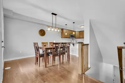 a kitchen and dining room with a table and chairs at Cozy 3BR Home with Parking Near Kitchener Attractions in Kitchener