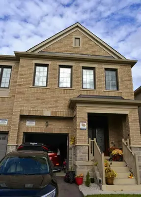 a house with a car parked in front of it at 1 Bedroom basement apartment with separate entrance in Milton