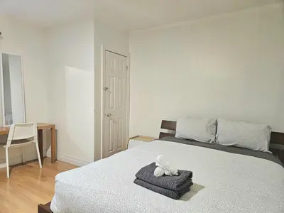 a bedroom with a bed with a teddy bear on it at Central Downtown Toronto - Trinity Bellwood Park in Toronto