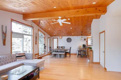 a living room with a couch and a ceiling fan at Cozy cottage on a private beach -Georgian Bay in Tiny