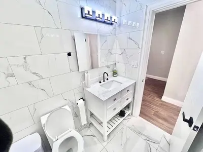 a white bathroom with a sink and a toilet at Private Room In Cambridge B8DW in Cambridge