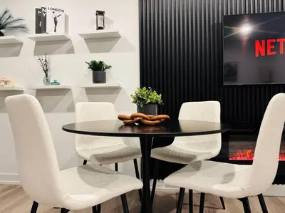 a dining room with a table and white chairs at Luxury Stay Near Niagara Falls in Niagara Falls