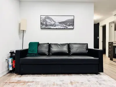 a black leather couch in a living room at Luxury Stay Near Niagara Falls in Niagara Falls