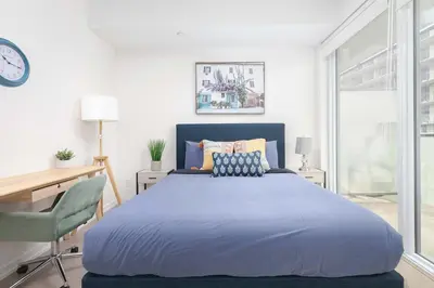 a bedroom with a large bed and a desk at 1BR Space - Downtown Toronto in Toronto